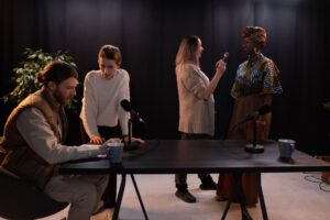 Production crew working on a podcast set in a dark studio