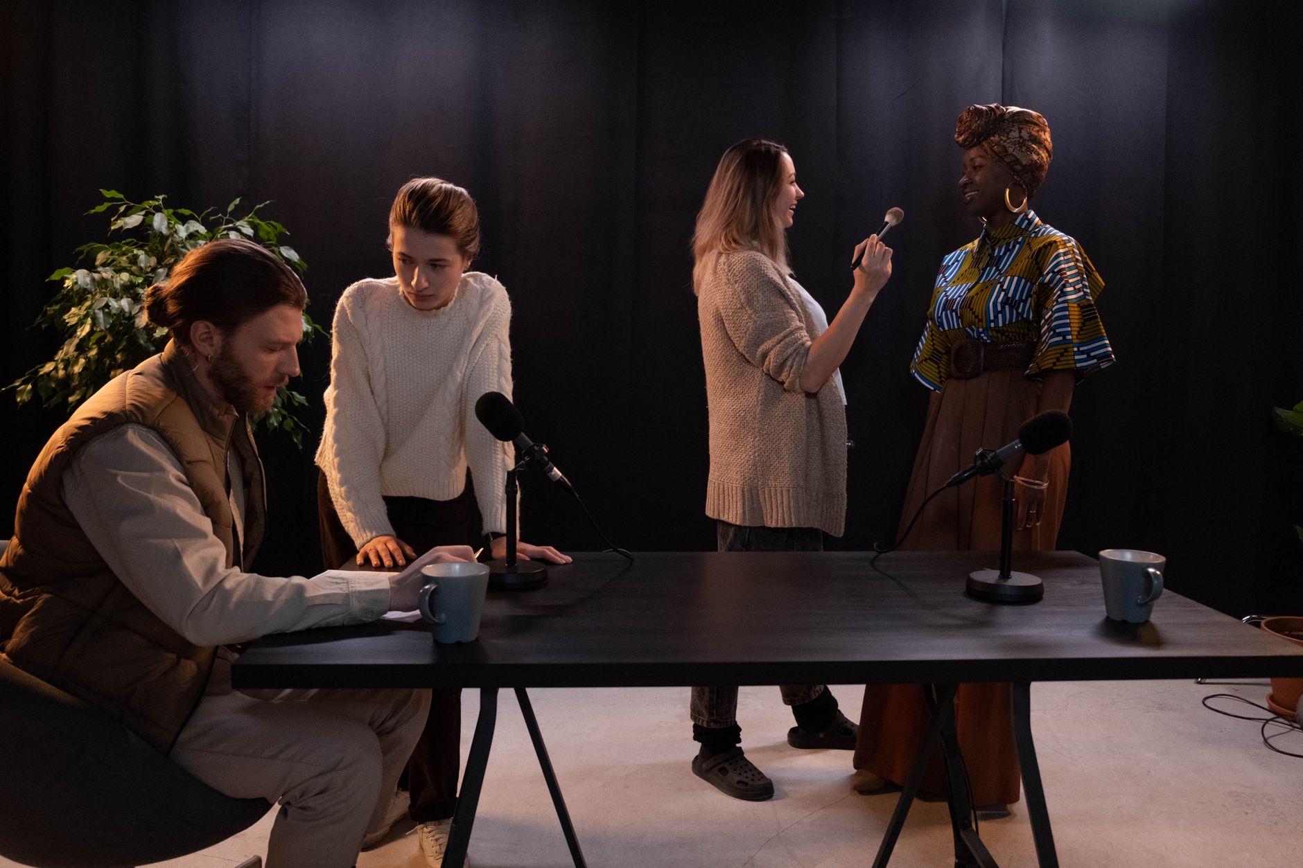 Production crew working on a podcast set in a dark studio